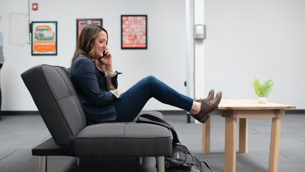 woman in blue denim jeans sitting on black office rolling chair